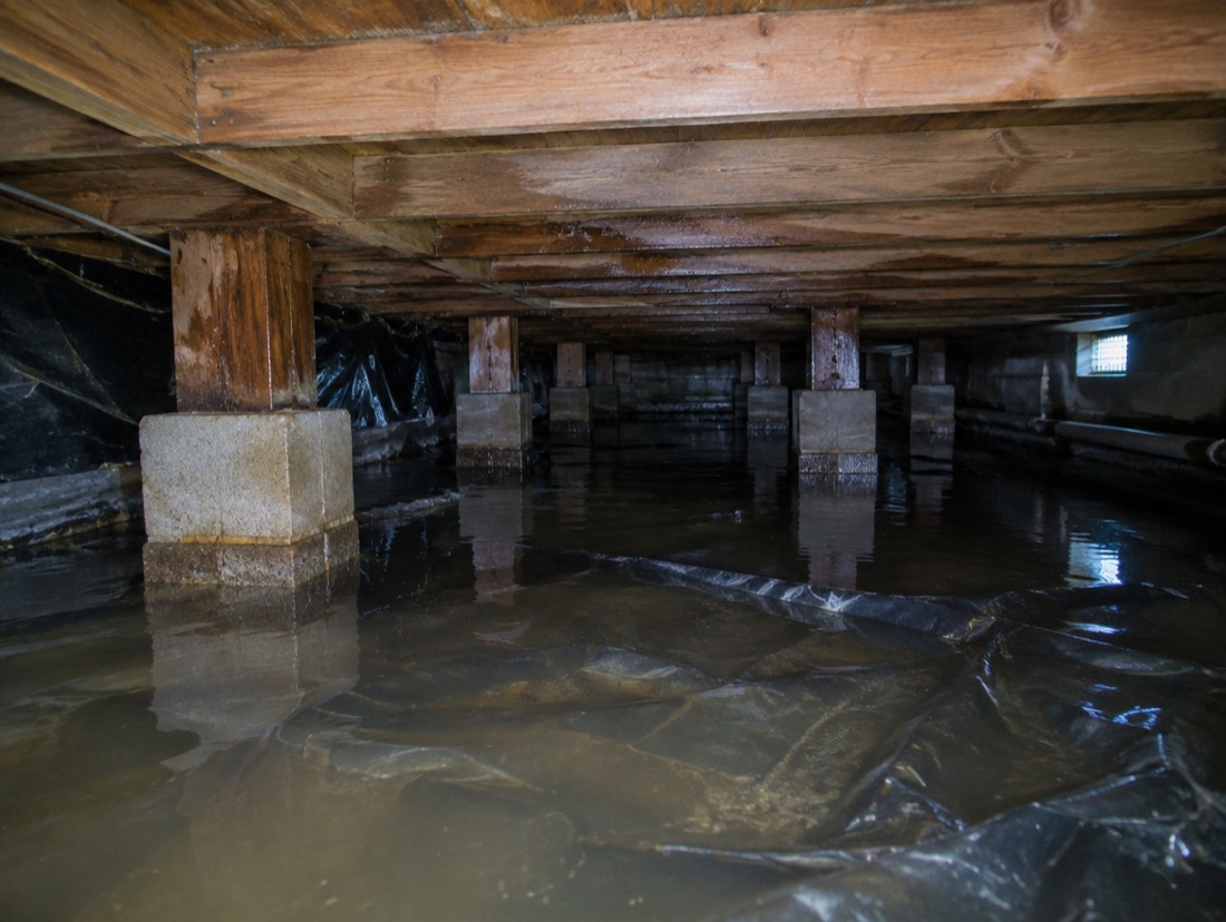 Flooded Charlotte crawl space with standing water over the vapor barrier after heavy rain